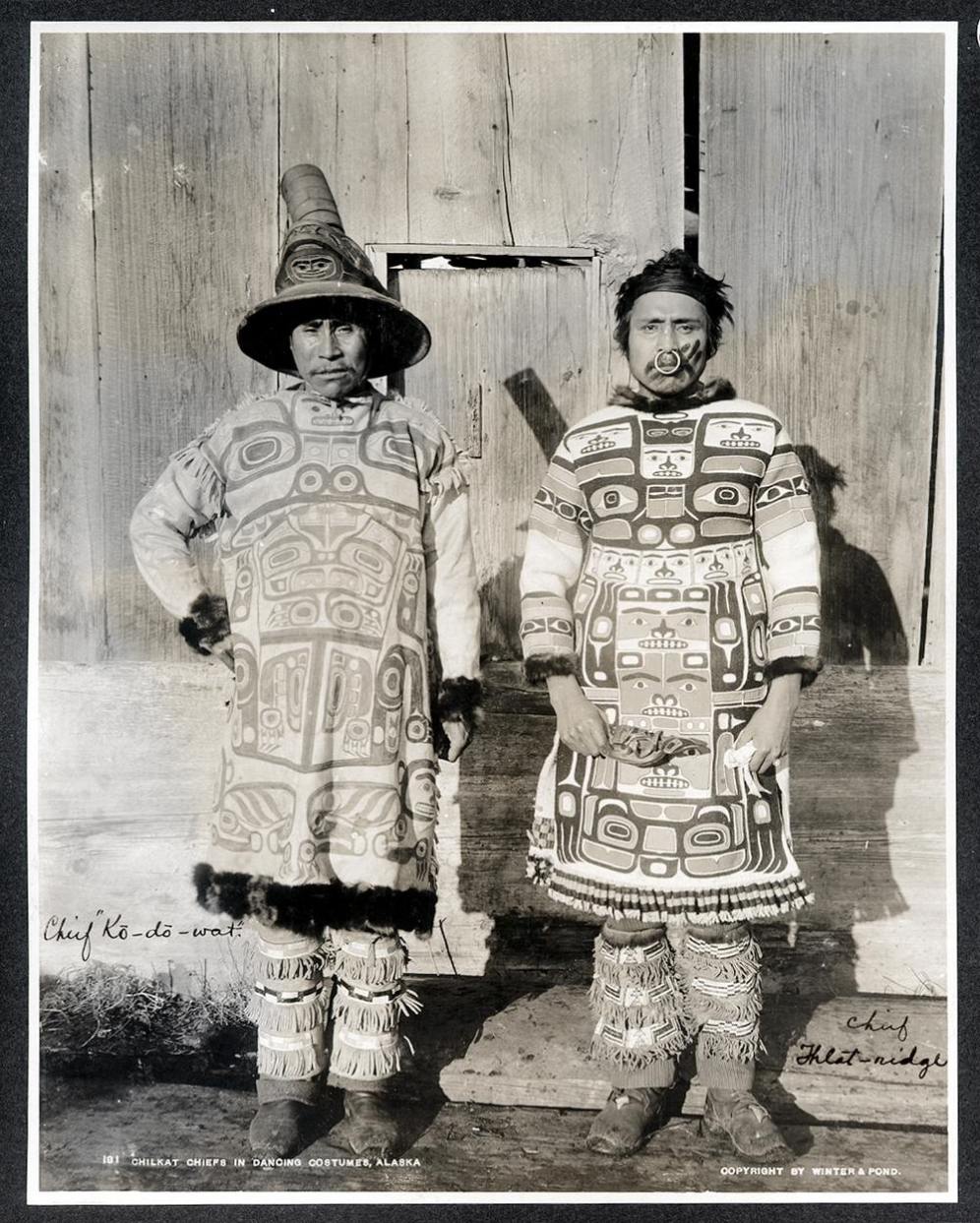 Chilkat (Tlingit) Chiefs in Dancing Costumes, Southeast Alaska. - Coudahwot and Yehlh-gouhu, chiefs of the Con-nuh-ta-di at Klukwan, wearing totemic design dance shirts and beaded leggings. Photographer: Winter & Pond, ca. 1895.:
